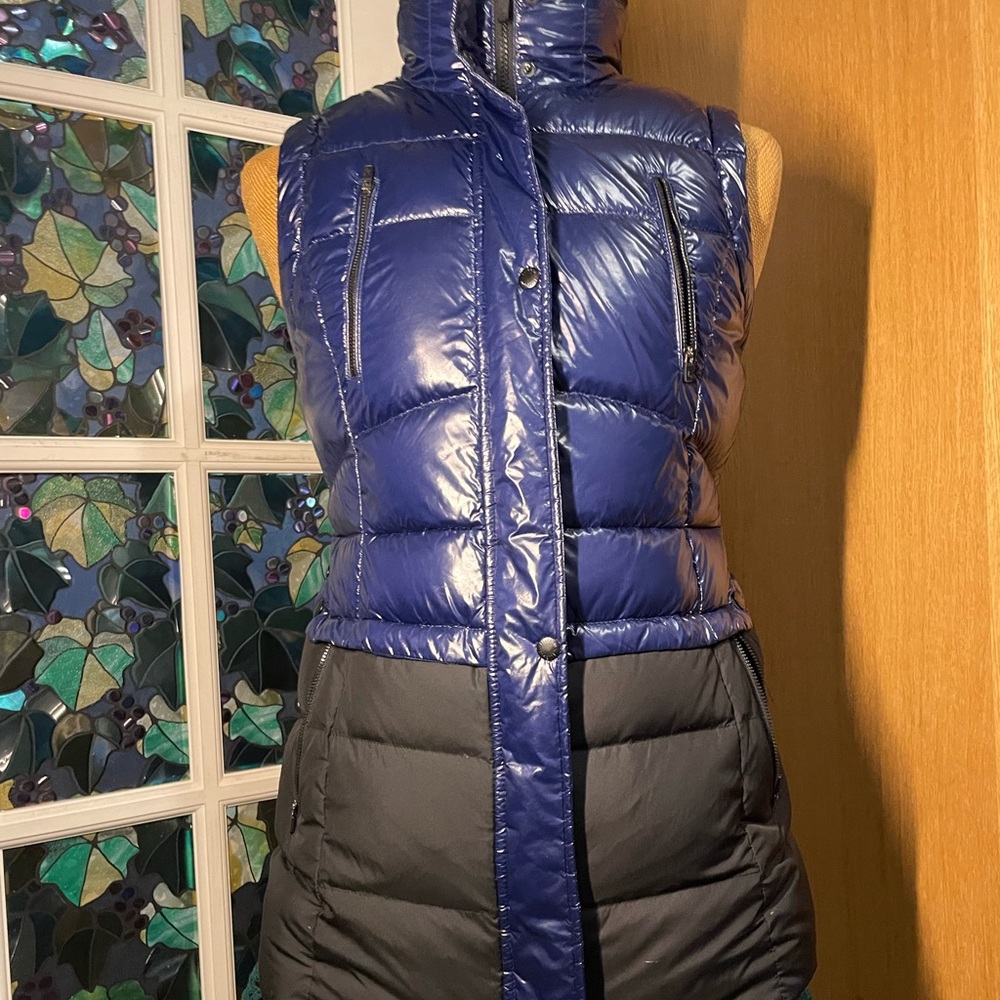 The blue puffer vest is a stylish, designed for both warmth and versatility.